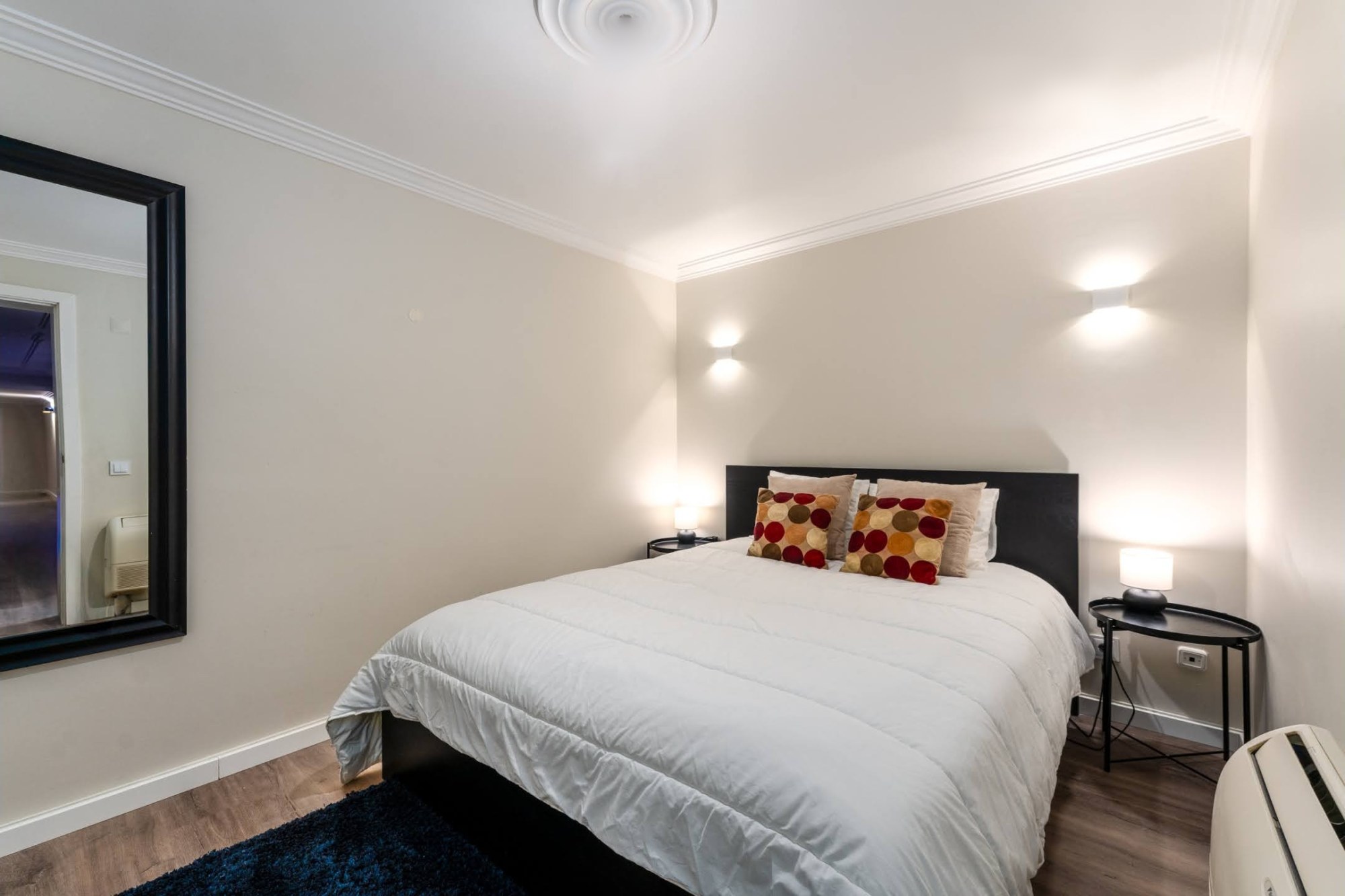 Staff Ensuite Bedroom #9 compact basement bedroom with no window and portable AC