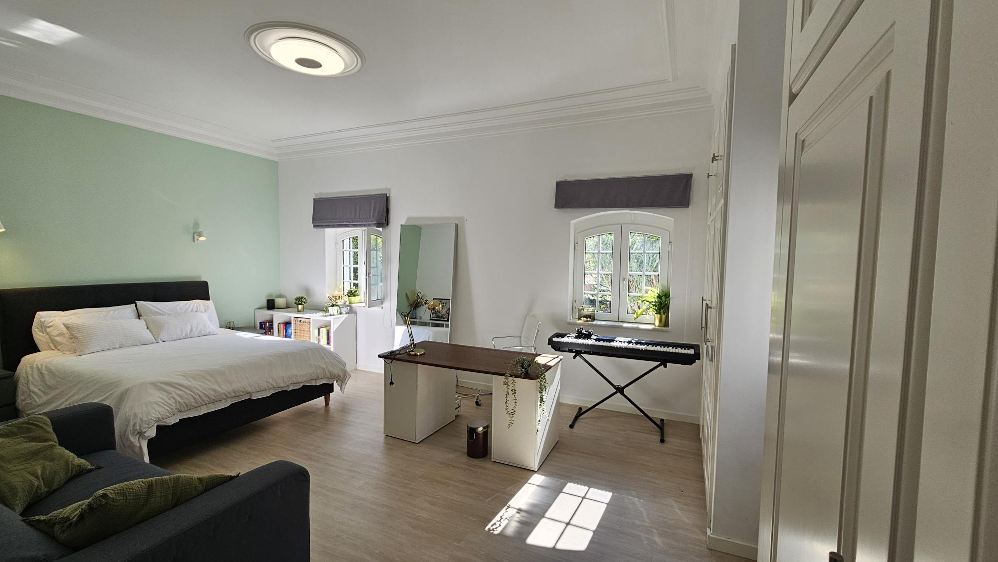 Ensuite Bedroom #5 with mint wall, bed and keyboard