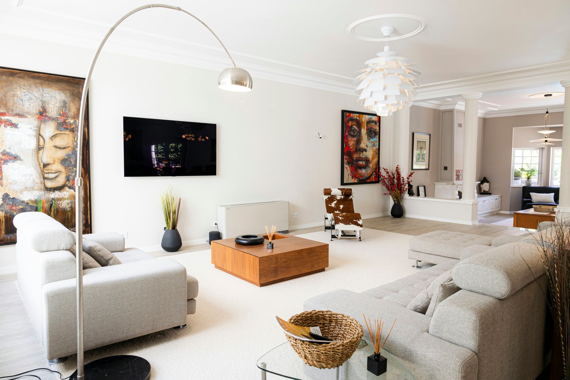 Grey sectional sofas, cowhide chaise and wall TV in the main lounge at Cascais Vacation, Cascais