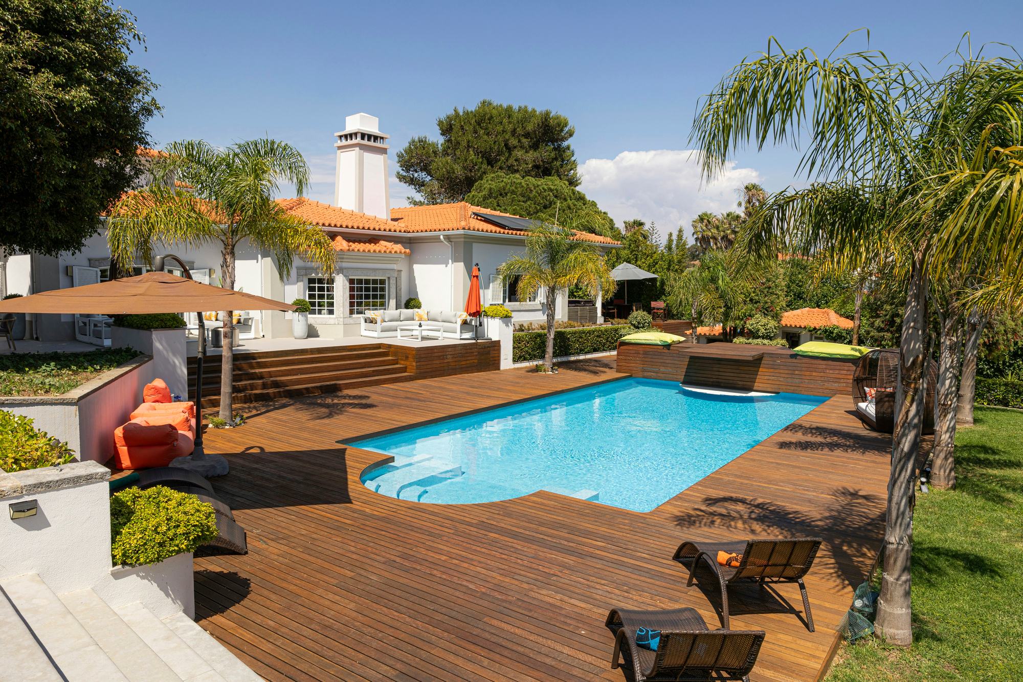 Pool with Roman steps, timber deck, palms and terraces at Cascais Vacation villa, Cascais, Portugal
