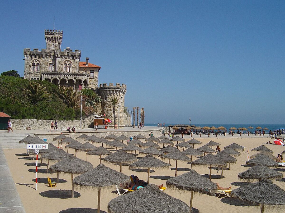 Praia do Tamariz in Estoril near Cascais, Portugal, with beach tents and the bay promenade